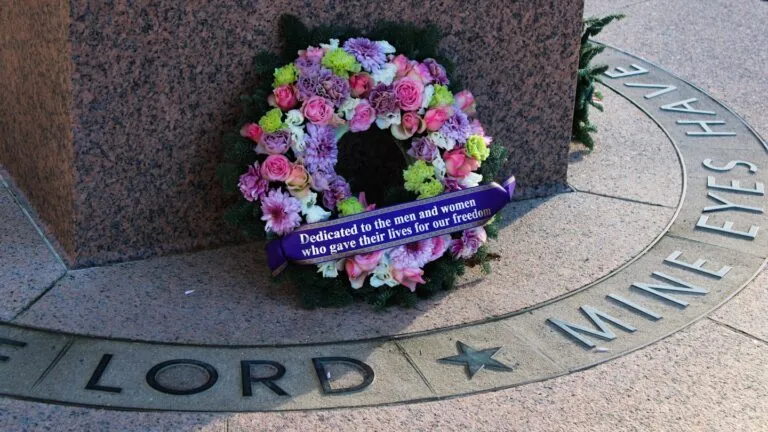 Family viewing a virtual memorial service on a laptop during online funeral planning